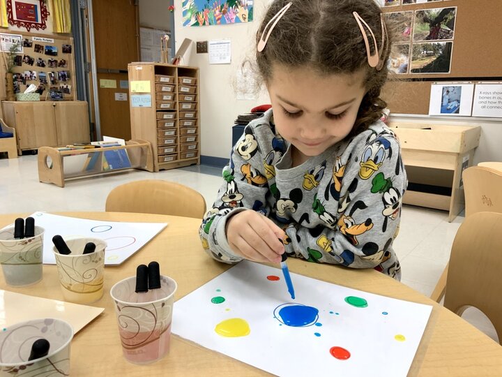 Girl painting at table